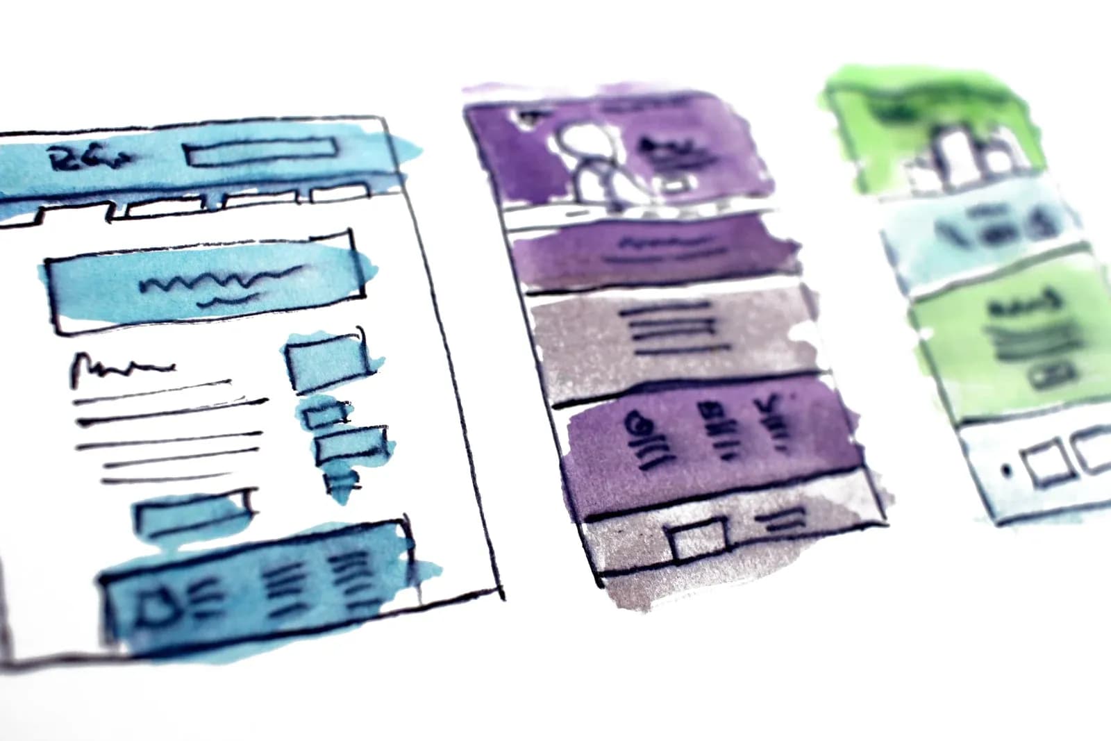Watercolor wireframe sketches of website layouts